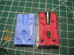 Initial setup for moulding using a wee plastic box.  Plasticine on the right is used to initially hold the object to be moulded 